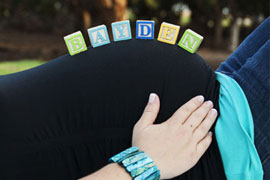 pregnant belly with babys name in blocks on it